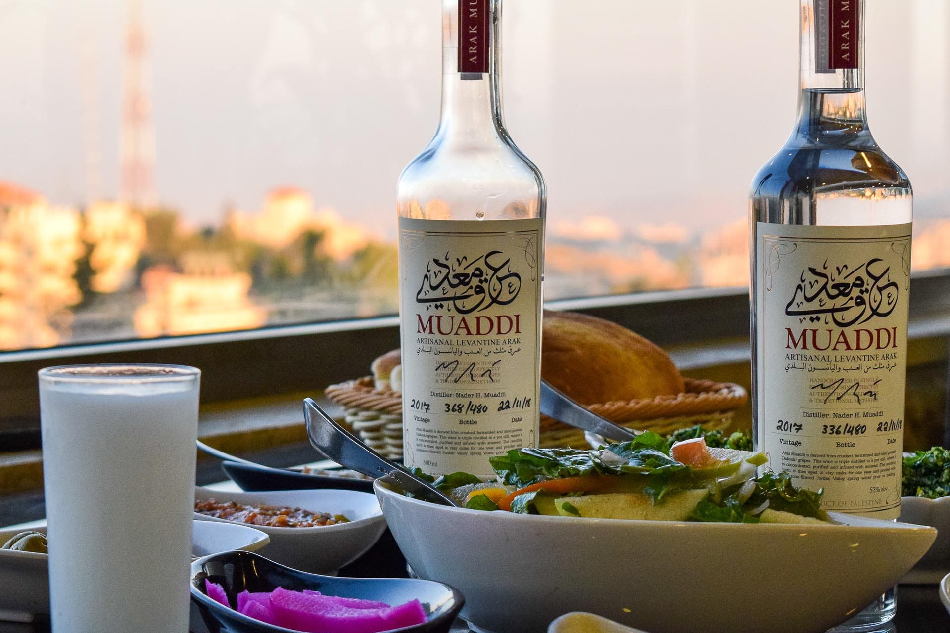 Arak displaying its signature hazy louche, with Middle Eastern cuisine / Photo by Gabriel Helou