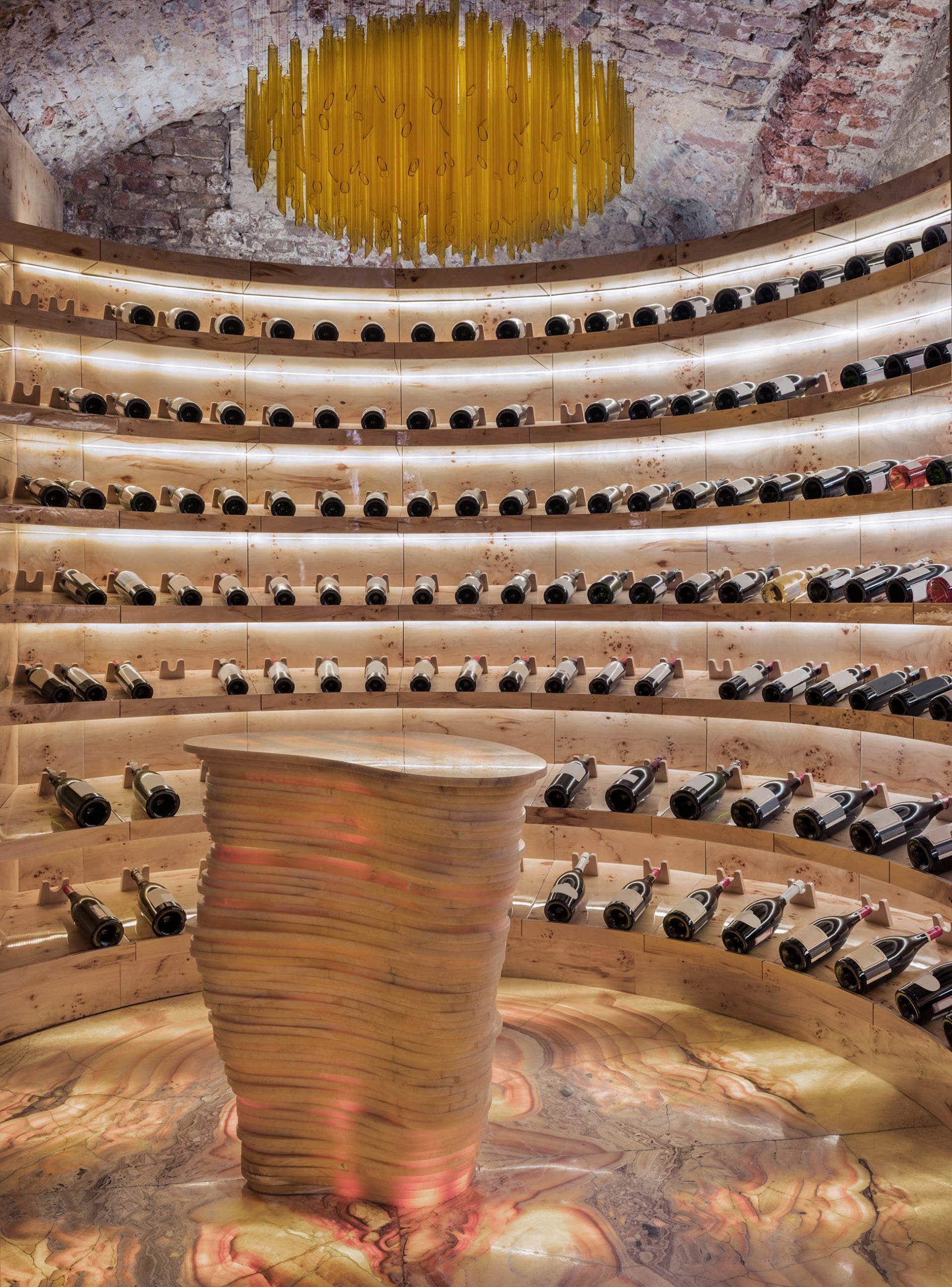 Seven wrap around shelves of wine in an expensive cellar